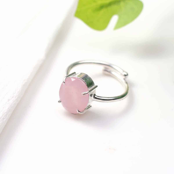 Rose Quartz diamond cut oval ring placed on a white table, promoting love, harmony, emotional healing and protection from negativity.