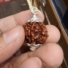 Load image into Gallery viewer, Round wooden table placed on a hand, showing its size and smooth finish against a white background.
