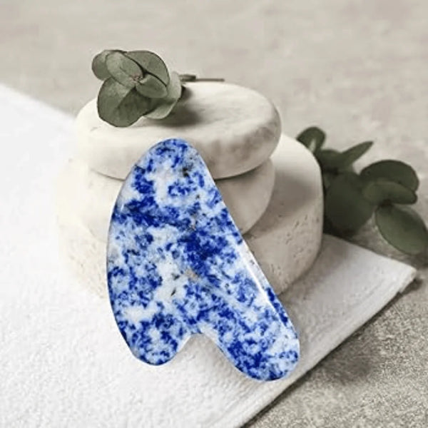 Blue Sodalite Gua Sha crystal showcased for facial relaxation, better focus and smoother expression.