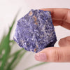 Sodalite raw stone held on hand, symbolizing logic, insight, and truth.