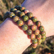 Load image into Gallery viewer, Lifestyle shot of a Unakite bracelet on a person&#39;s wrist, emphasizing comfort and beauty.
