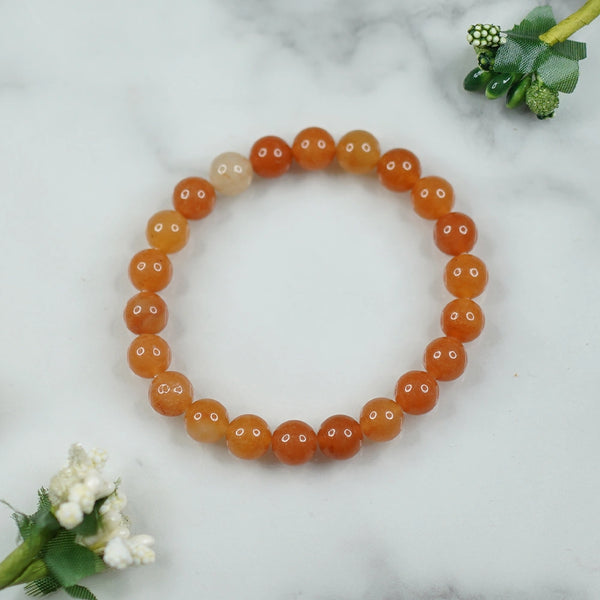 The Red Aventurine bracelet with a focus on its vibrant color and unique texture.